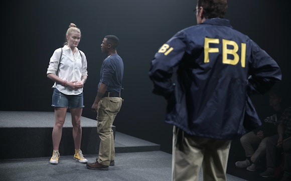 Woman being questioned by FBI agents.