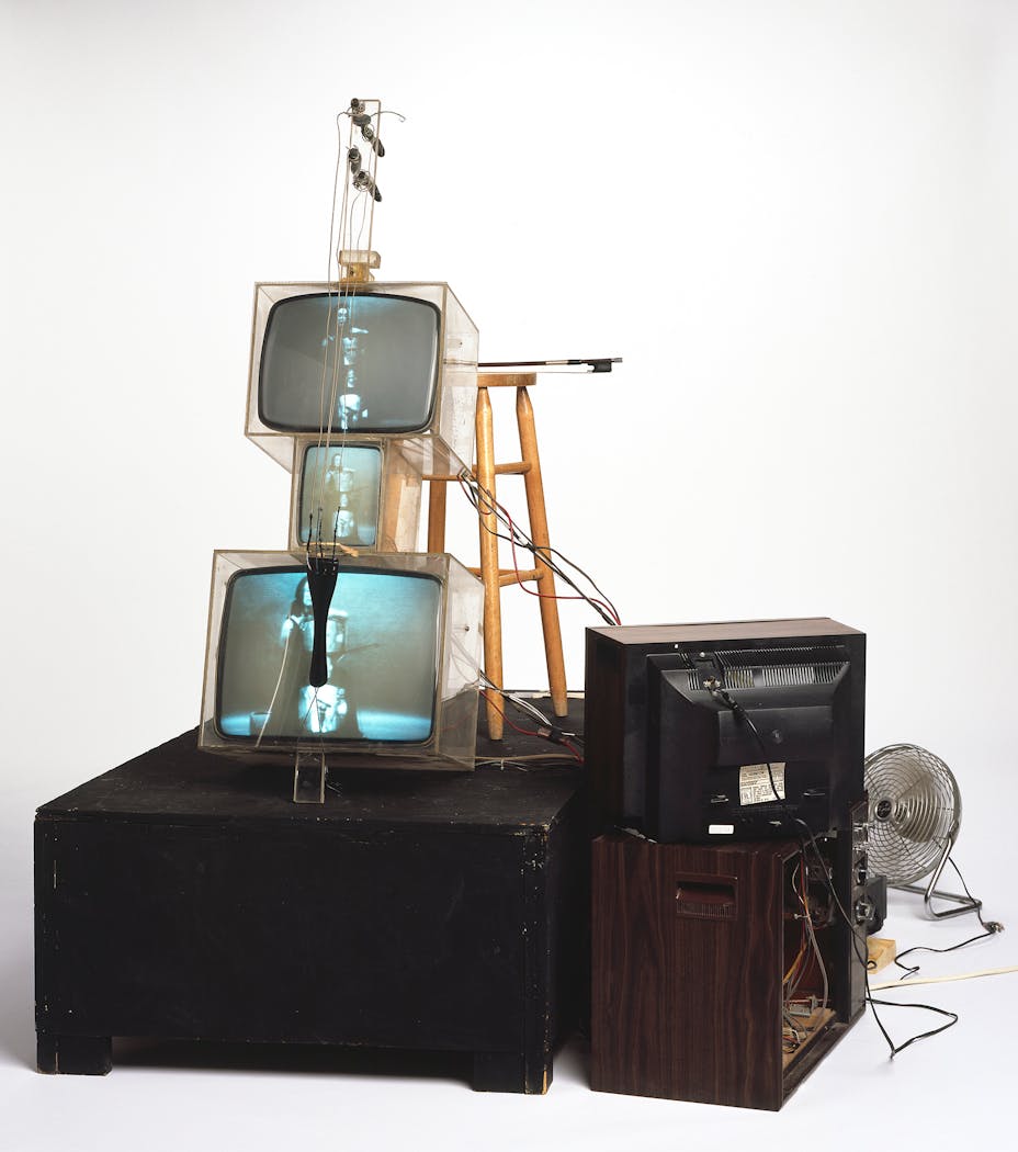 Nam June Paik, TV Cello, 1971, video tubes, TV chassis, plexiglass boxes, electronics, wiring, wood base, fan, stool, photograph. © Estate of Nam June Paik. Courtesy Walker Art Cente