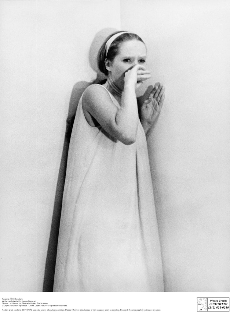 Woman standing in corner and covering a scream