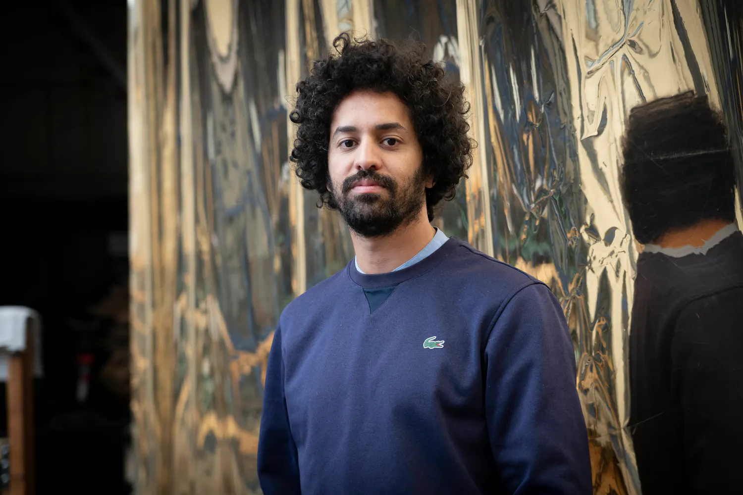 Portrait of man in front of distorted mirror background