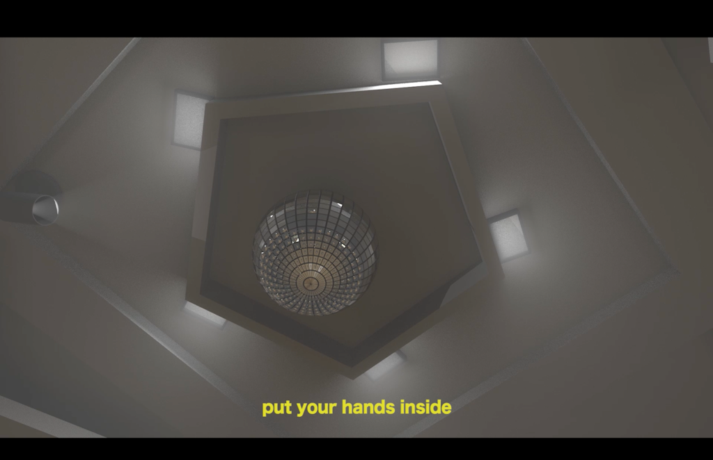 A view of a disco ball on the ceiling in a grey hexigon shape with a can light. Text on the bottom says in yellow: put your hands inside.