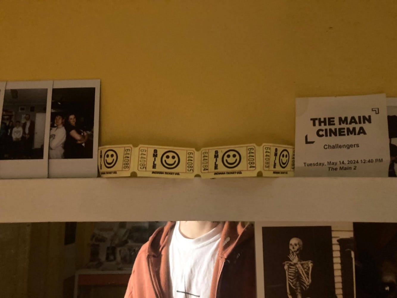 an arrangement of tickets and photos along the top edge of a mirror