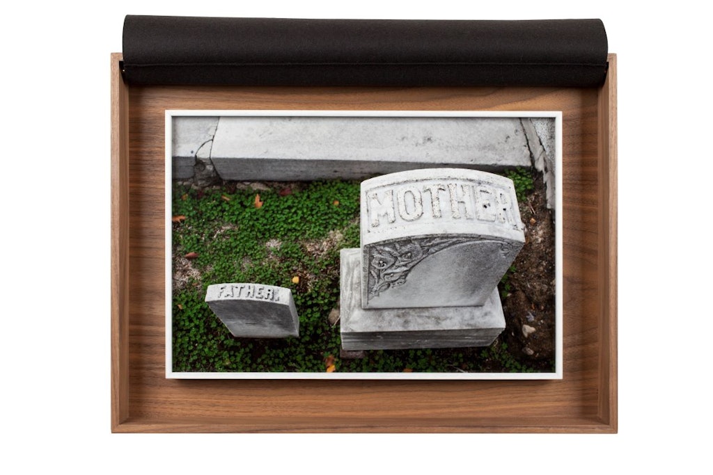 A picture of a gravestone, a large one reads Mother smaller one reads Father.