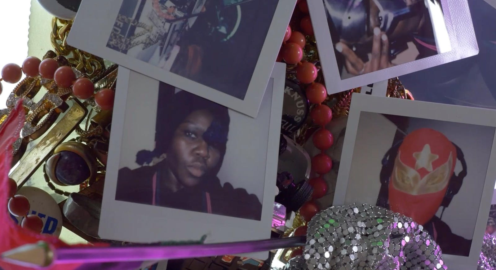 Various photos of a dark-skinned performer with different masks on.