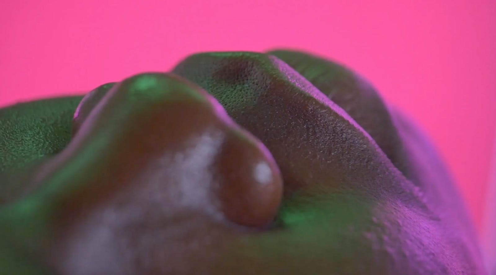 Overhead close-up photograph of a dark skinned performers nose and lips.