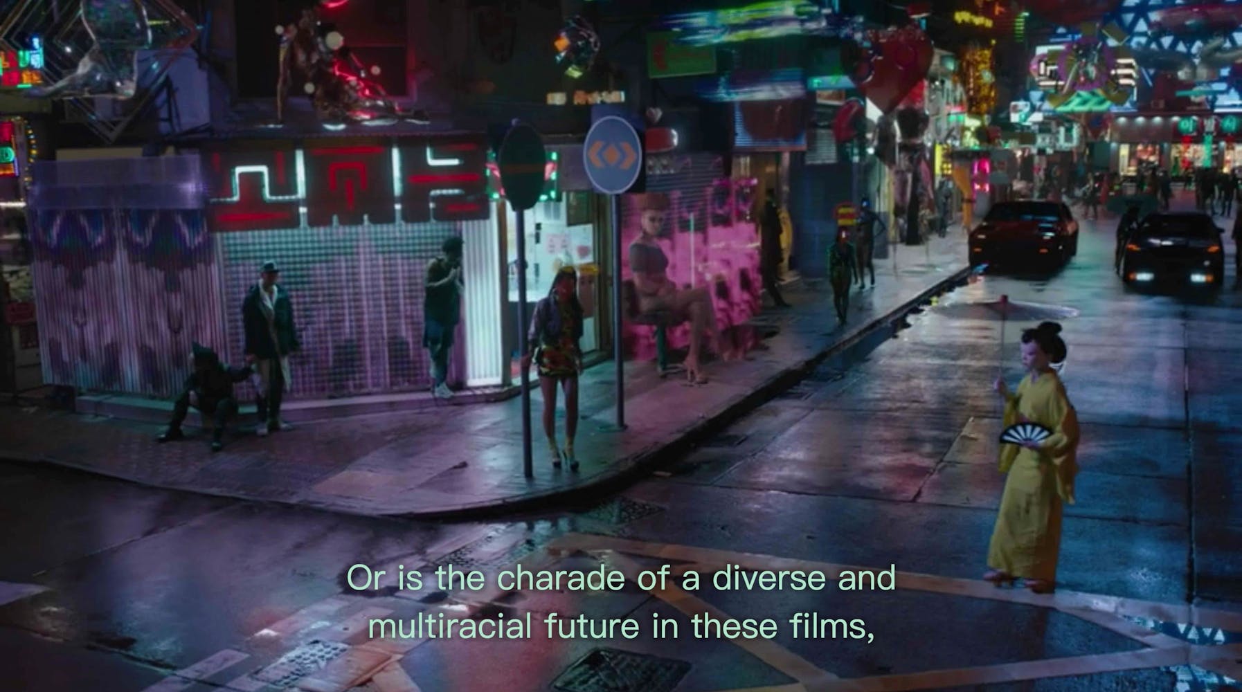 A woman walks across a city street corner with subtitles “Or is the charade of a diverse and multiracial future in these films,”.