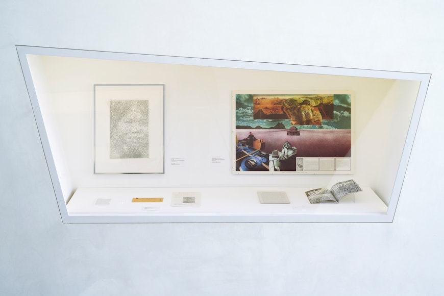Image of display case featuring prints and various ephemera