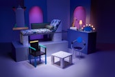 Several pieces of 80's-modern and colorful patterned furniture arranged in a space, lit with blue and purple slights.