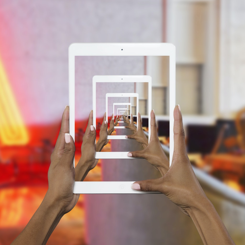 A group of green role playing dice lay on a white counter.