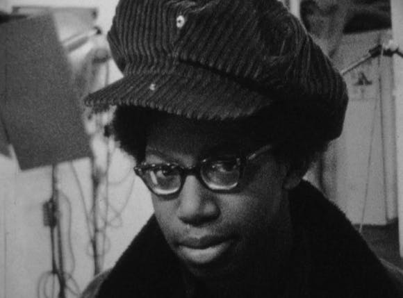 Portrait of a young boy in hat and glasses in the Film in the Cities studio.