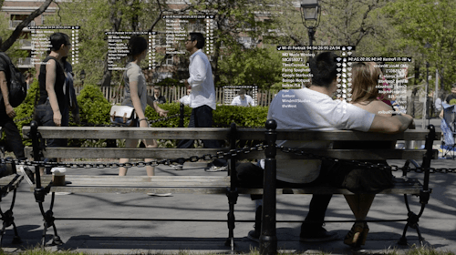A scene of people in the park with WiFi text overlayed onto their upper torsos.