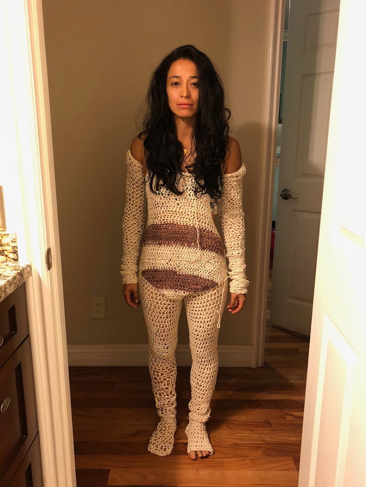Woman standing in hallway in knit outfit