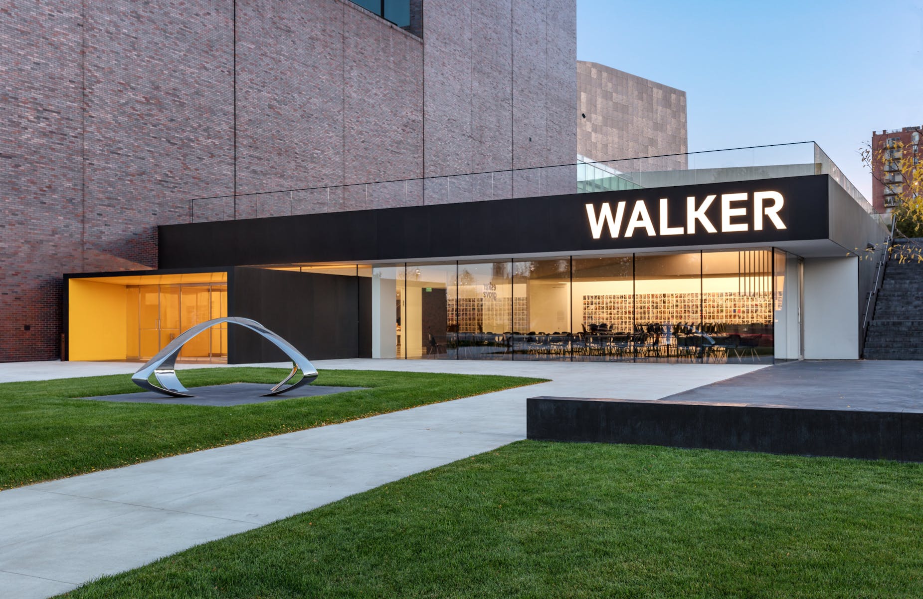 Walker Art Center building facade with grass and metal sculpture in foreground