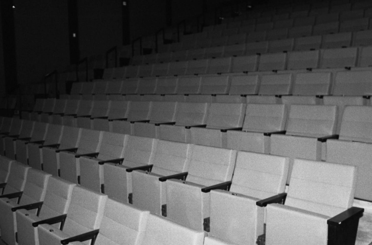 Black and white image of the seating in an empty cinema.