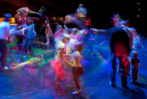 motion blur children dancing under black lights