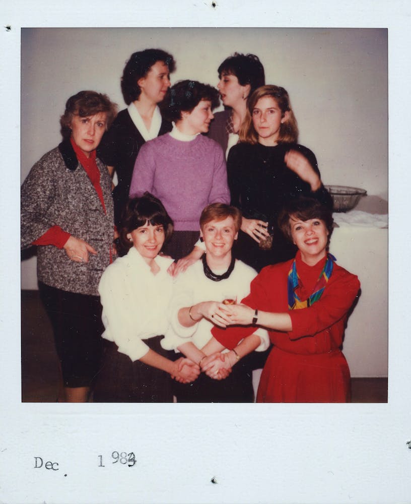 A group of adult pose for a photo.