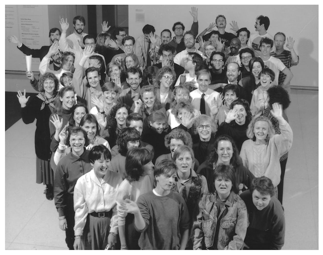 A group of adult pose for a photo.