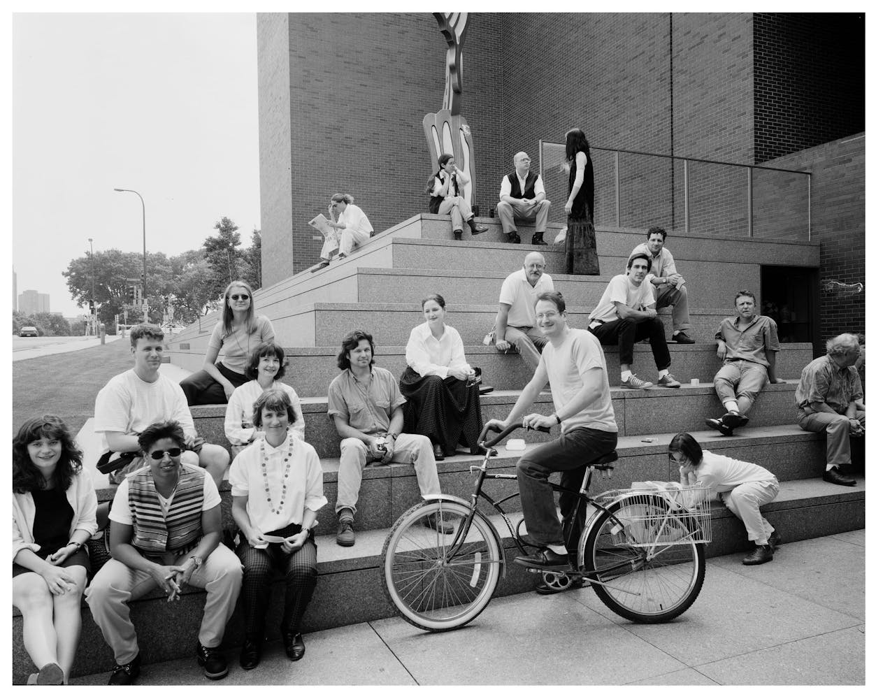A group of adults pose for a group photo outside of the museum.