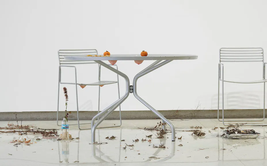 patio table with with two oranges on it