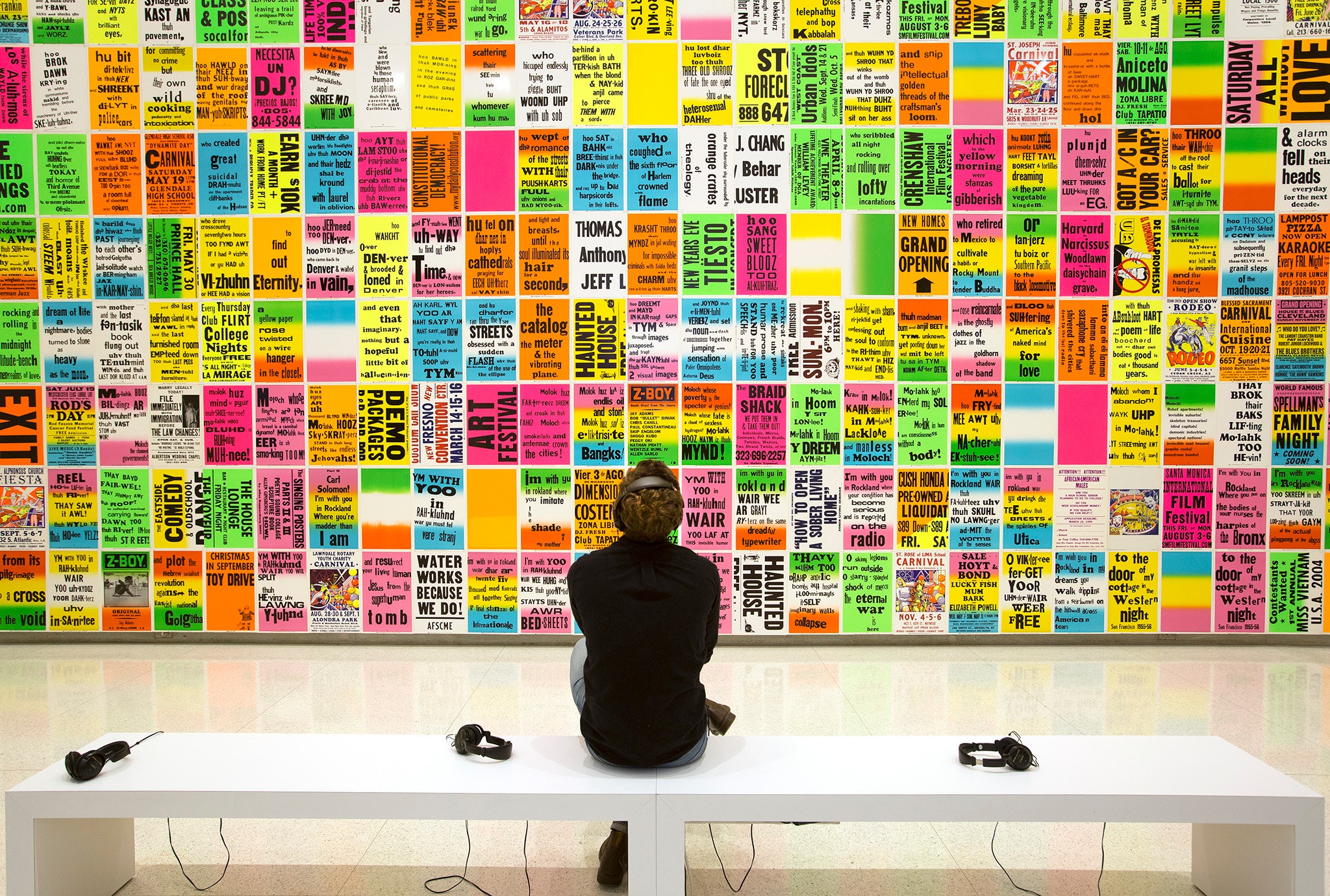 Man sitting in front of Ruppersberg artworks