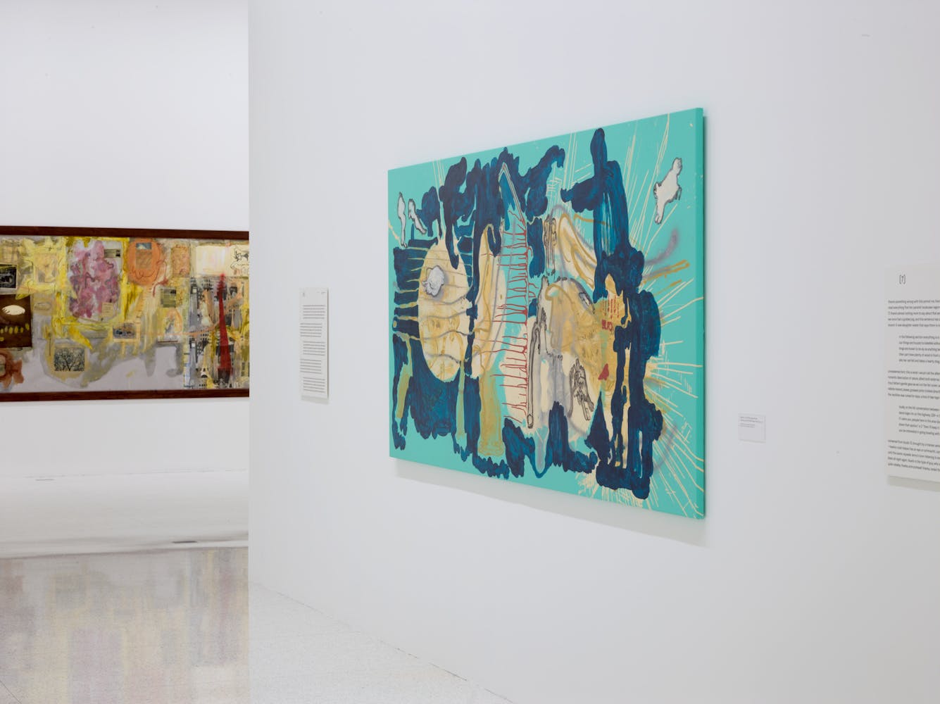 Image of abstract artworks hung on walls in gallery space with white walls.