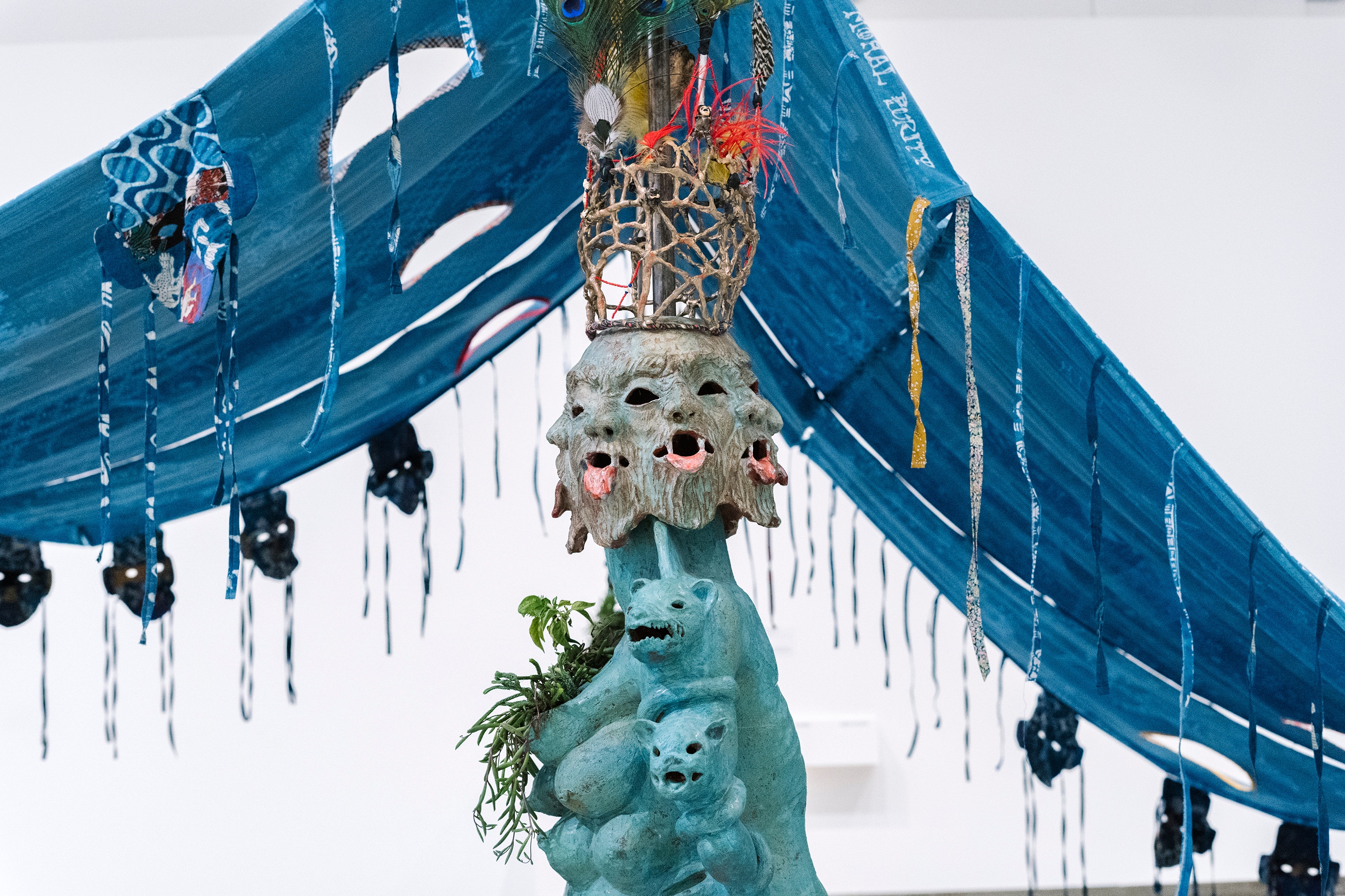 Blue fabric tent with multicolored sculpture underneath