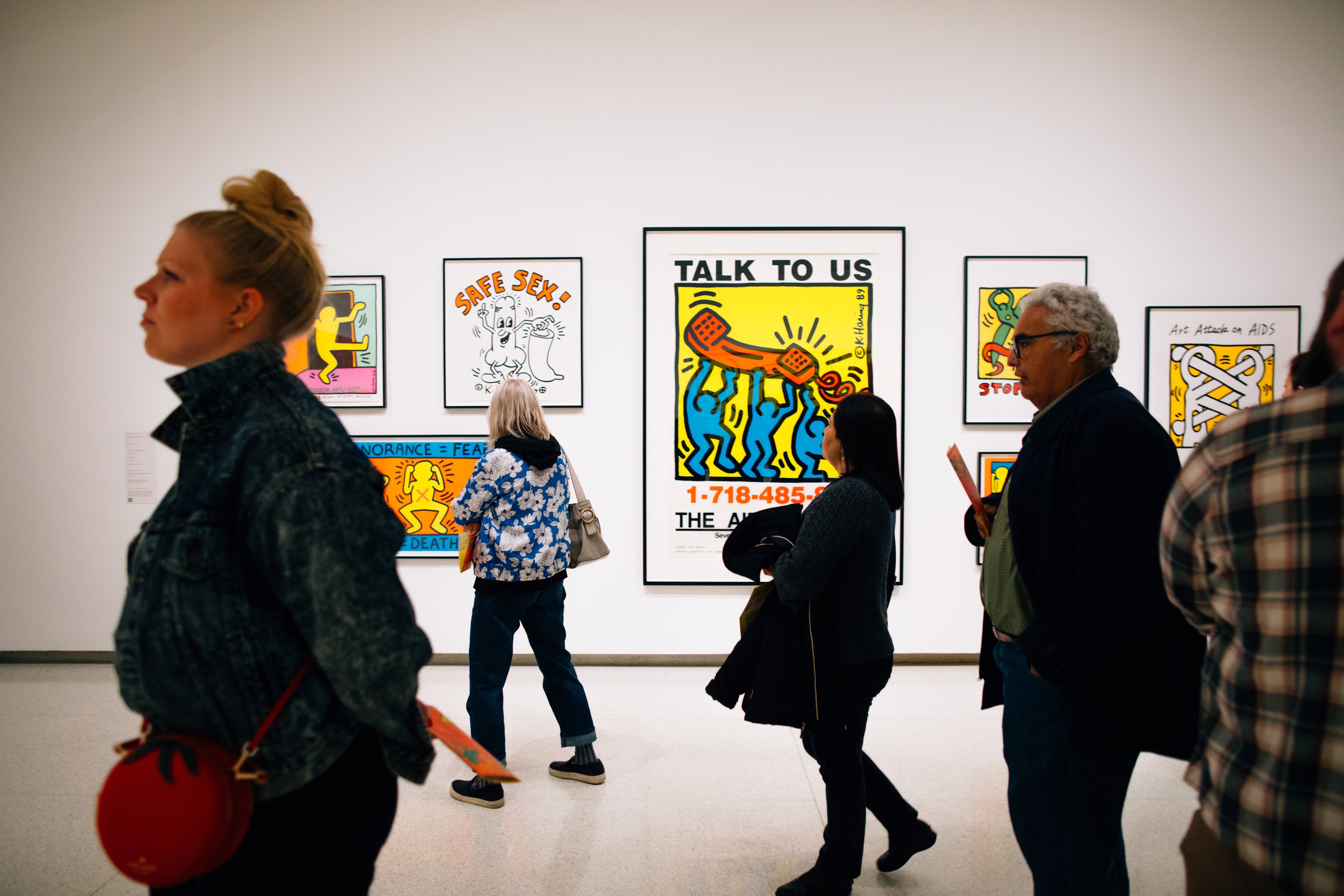 People walking in action in the Keith Haring exhibit.