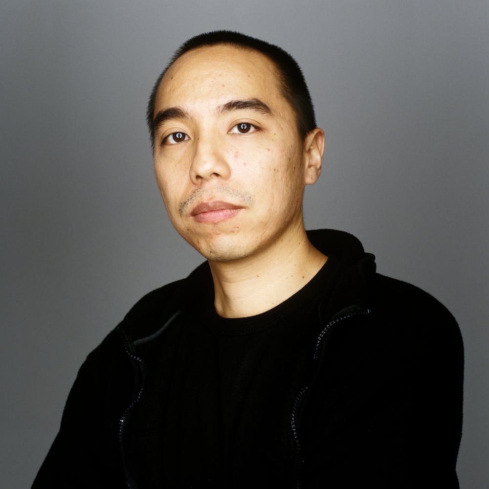 A man sits and looks at the viewer.