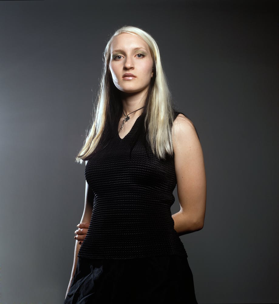 A woman looks at the viewer