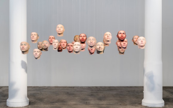 20 floating heads in a gallery with two columns