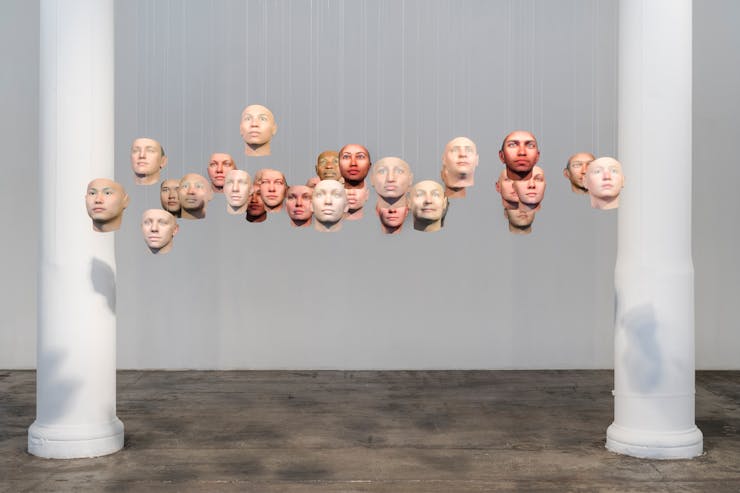 20 floating heads in a gallery with two columns
