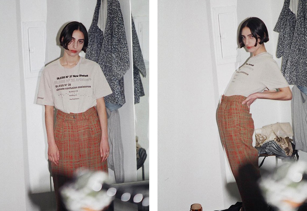 Portrait of a person modeling a bless tee shirt wearing orange pants