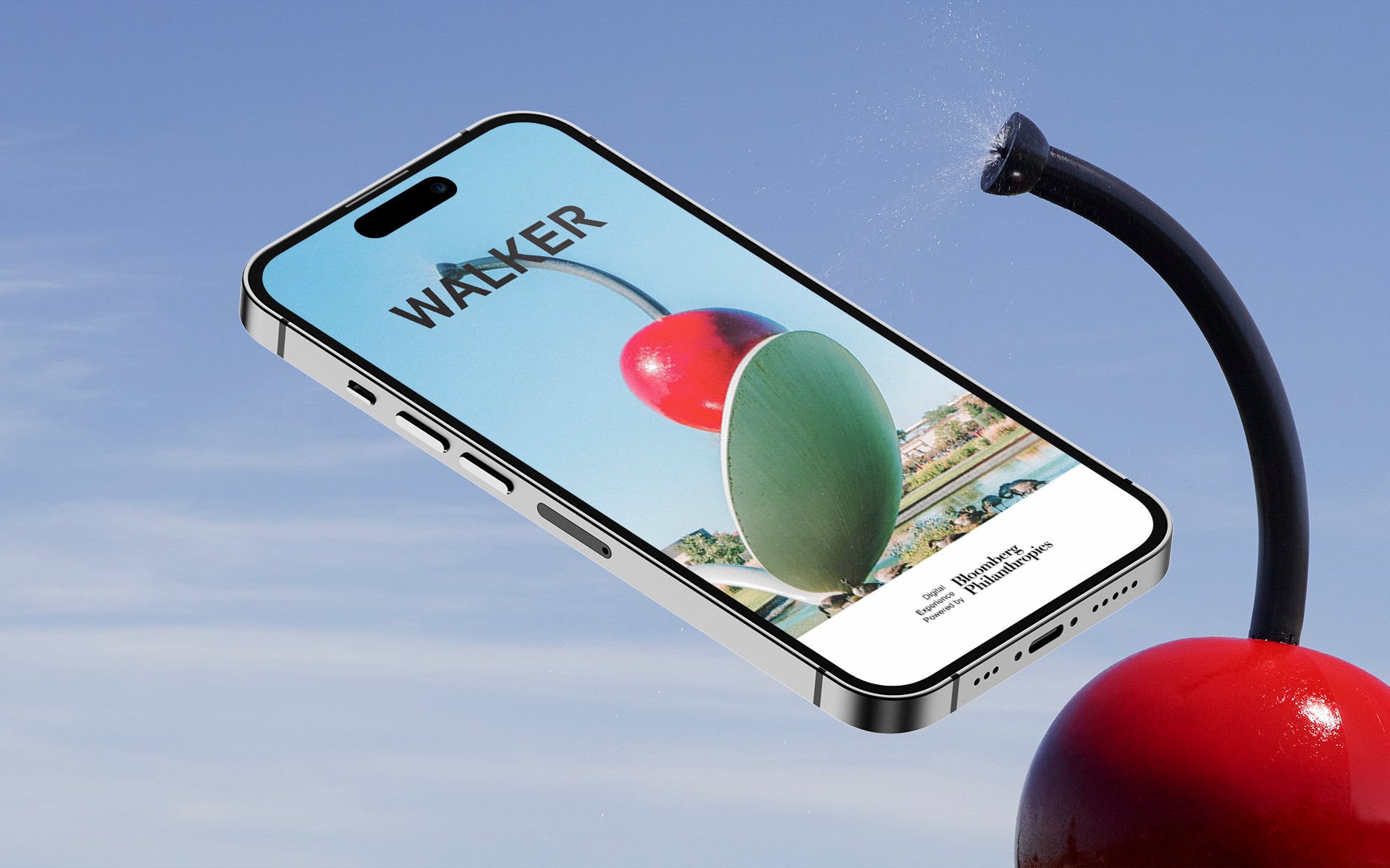 An iphone with an image of a large sculpture of a cherry resting in a spoon floats in the sky.