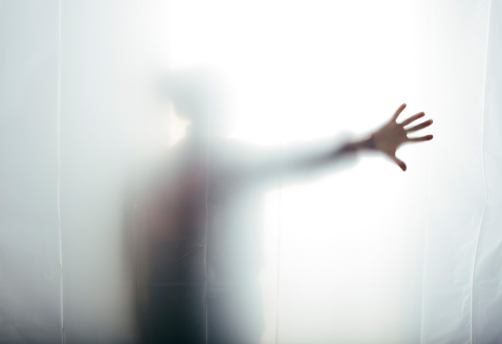 Person behind translucent screen