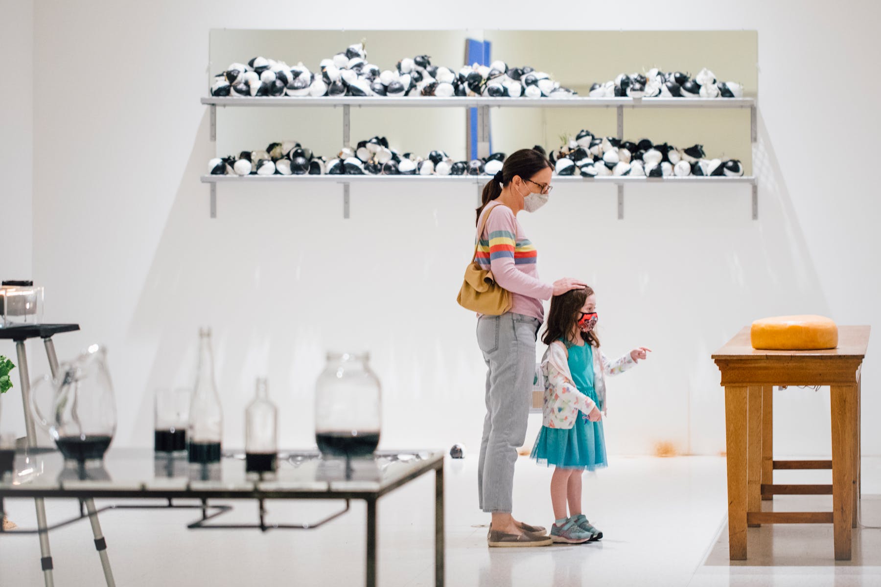 Woman and girl in gallery with beakers in the foreground