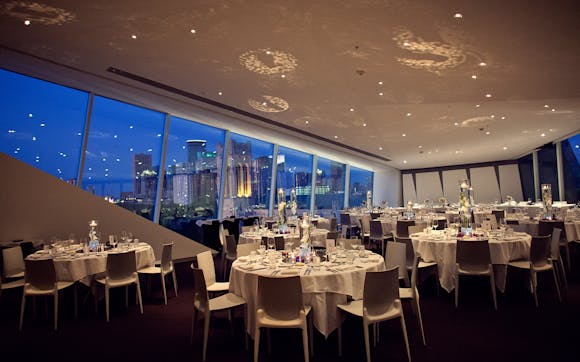 Skyline Room set for evening dinner with Downtown view at dusk
