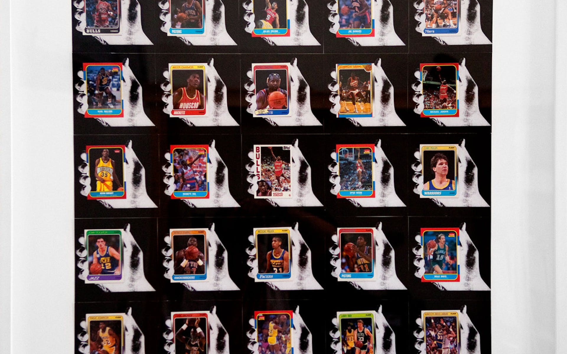 Framed artwork consisting of a grid of images of hands holding cassette tapes