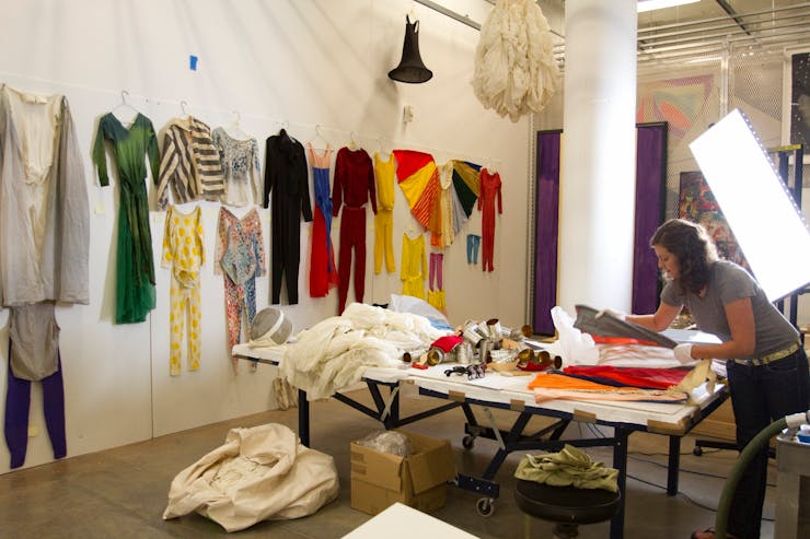 Early cataloguing days. Abigail Sebaly folds a costume designed by Robert Rauschenberg. Photo: Gene Pittman