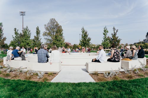 Visitors gather and sit on Angela Two Stars's Okciyapi (Help Each Other) in the Minneapolis Sculpture Garden.