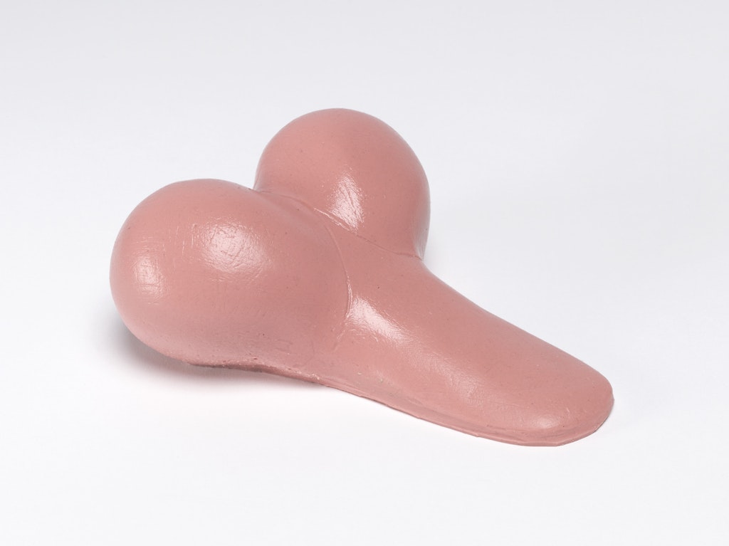 A pink phallic object sits in a white space.