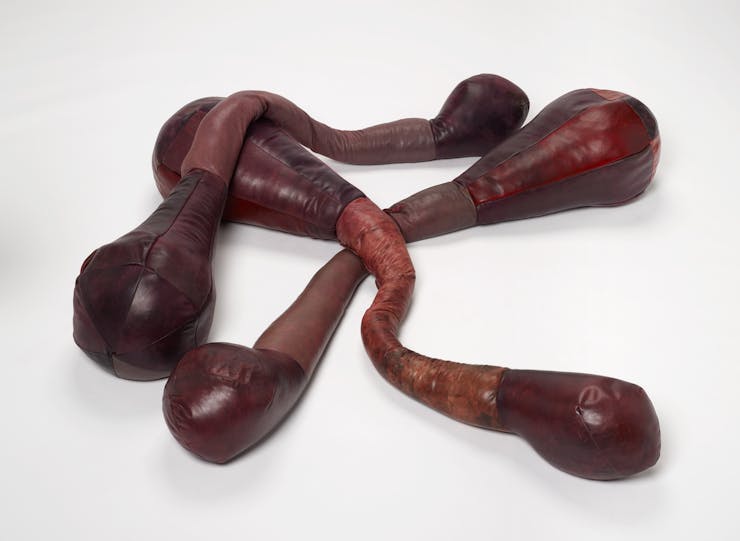 Brown sculptures leaning on each other