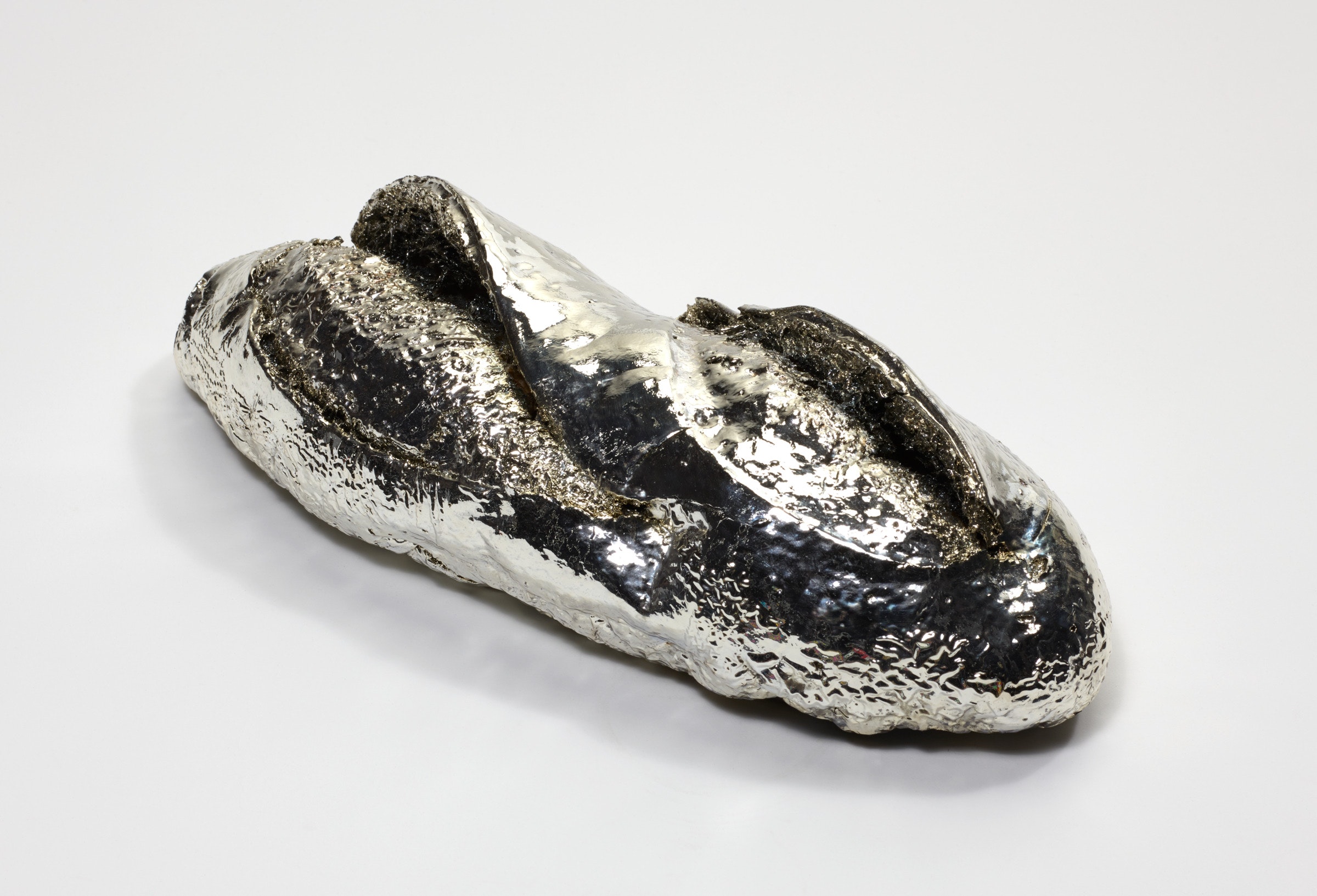 A silver sculpture of a ba·guette