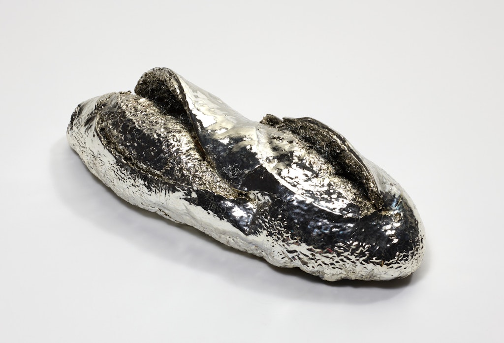 A silver sculpture of a ba·guette