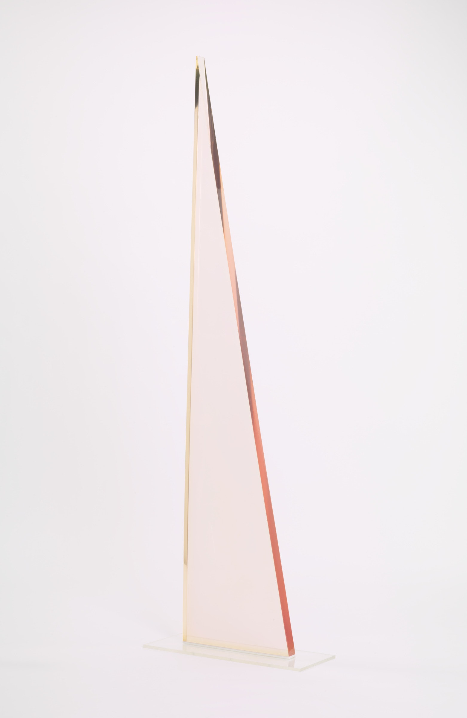 A translucent triangular object in a white space.