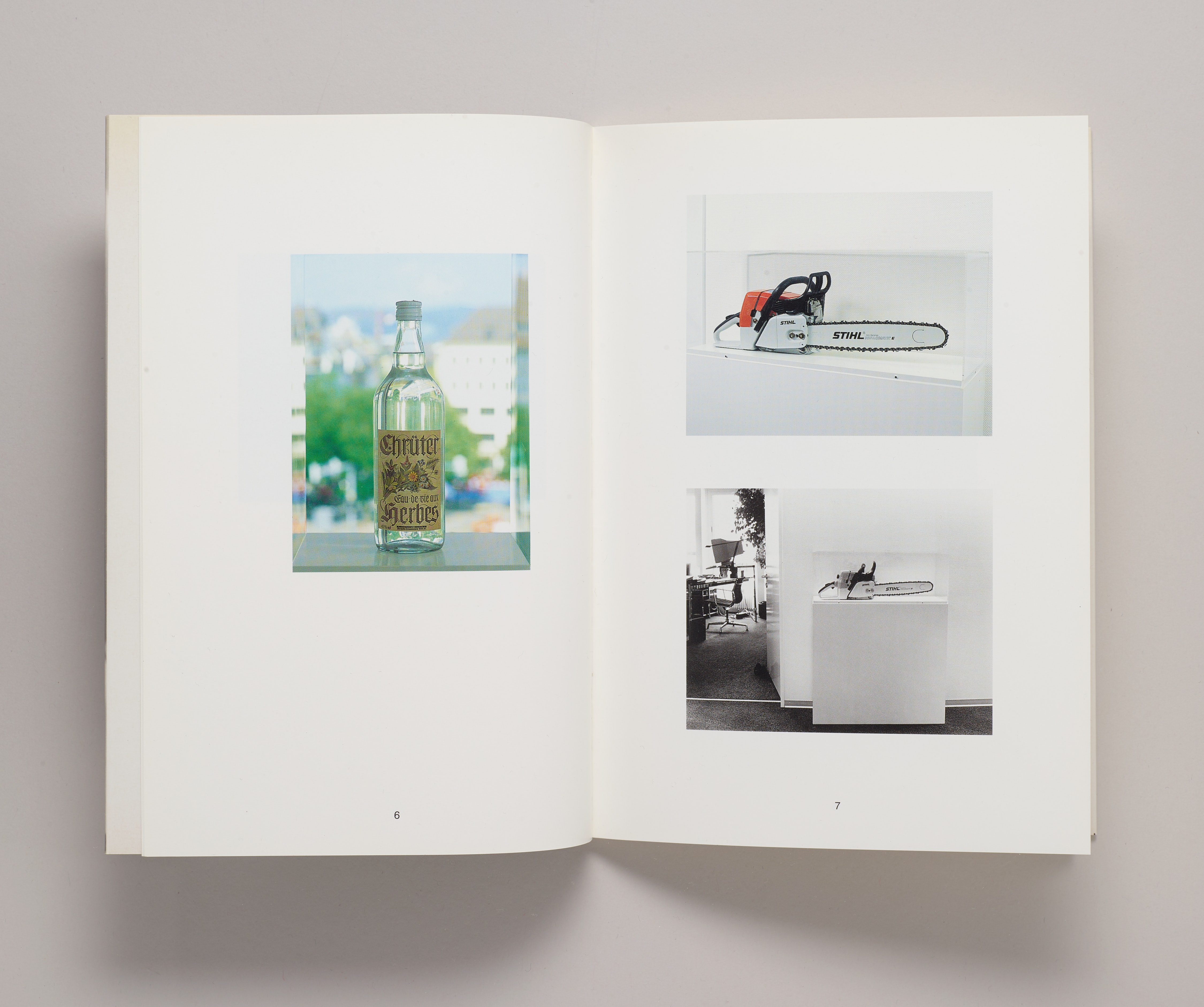 An open book with photographs of chainsaws and a glass bottle.