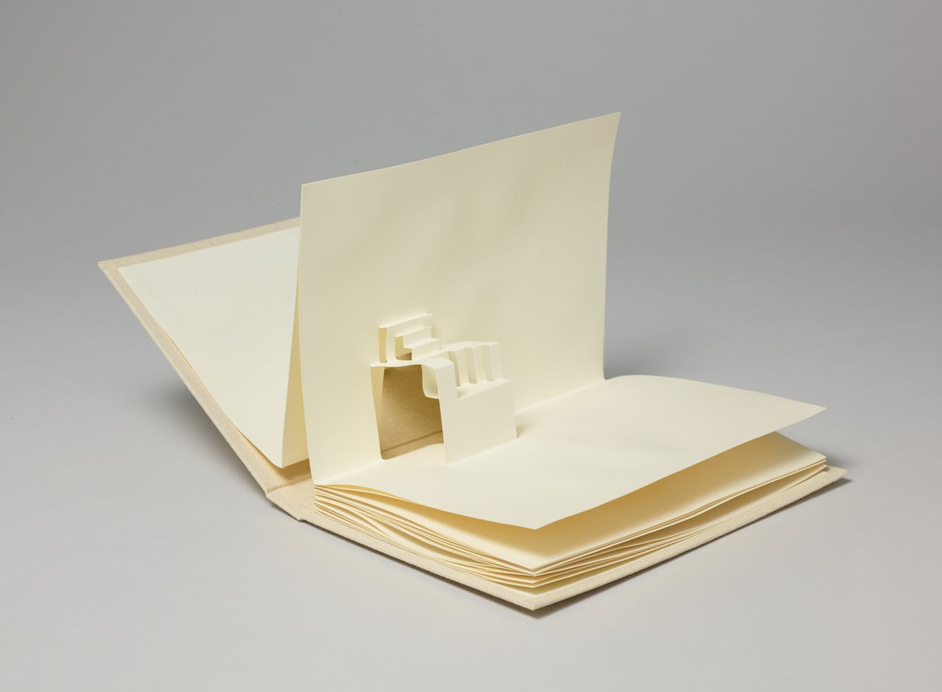 A open book has blank pages that create a pop-up book of a set of stairs.