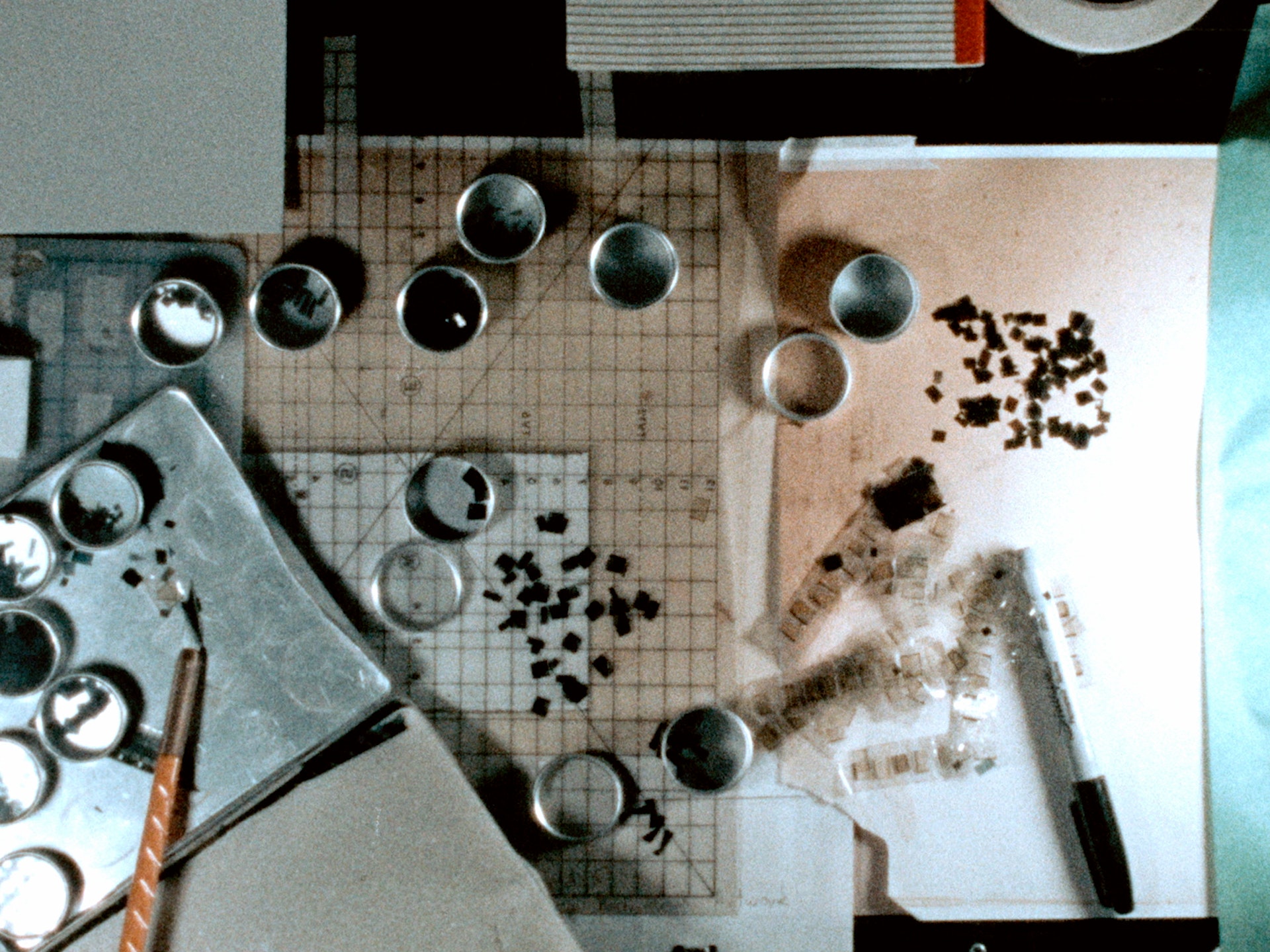 Top view of art materials and film on a table.