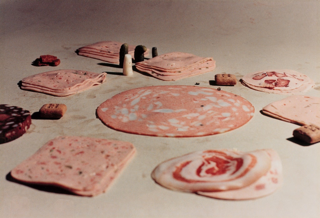 Photograph of cute deli meats on a flat surface.