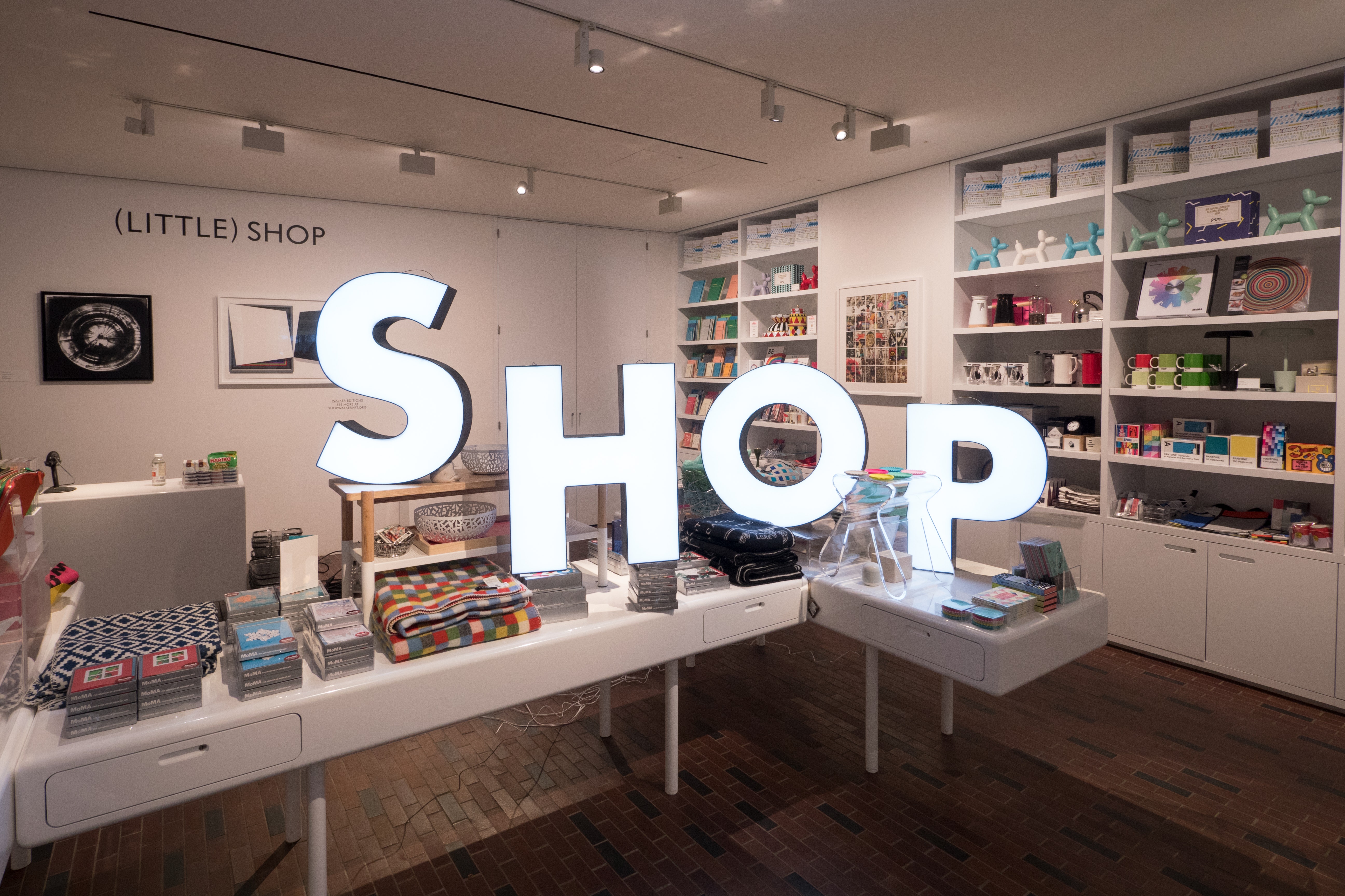 Large glowing letters placed within the Walker's Shop spell out the word "shop."