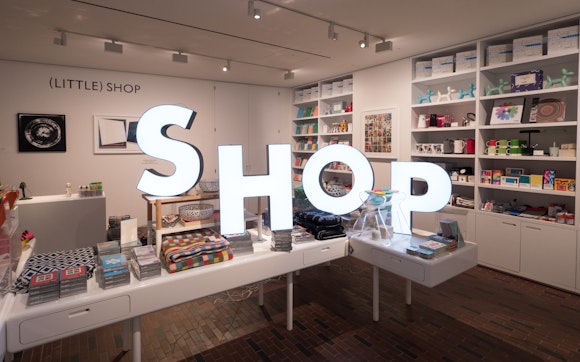 Large glowing letters placed within the Walker's Shop spell out the word "shop."